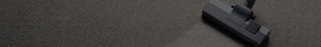 Vacuum cleaner on a dark carpet